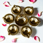 7-inch decorative mini urli bowl with 6 brass diya holders, perfect for Indian festive decor.